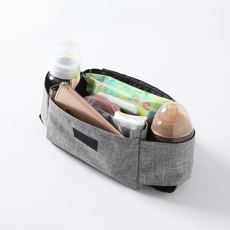 Gray fabric organizer with baby items on a white background