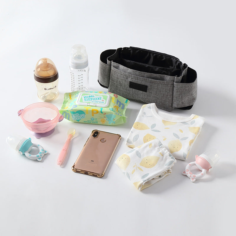 Collection of baby care items including a bottle, wipes, and a phone on a light background